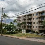 Maui vacation rental condominium building with For Sale sign representing Bill 9 phase-out impact