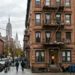 New York City residential brownstone buildings representing the neighborhoods affected by Local Law 18 short-term rental enforcement