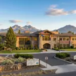 Bend Oregon government building with Cascade Mountains in the background representing STR permitting and zoning regulations