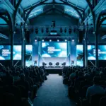 Short Stay Summit London 2026 conference venue with modern stage setup and dramatic lighting