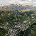 Aerial view of Jackson Hole Wyoming valley surrounded by protected mountain wilderness illustrating geographic supply constraints in STR markets