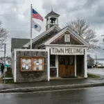 Coastal New England town hall representing municipal STR permit cap regulations