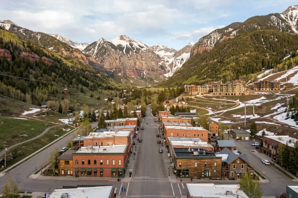 Telluride Colorado mountain town box canyon with Victorian buildings and snow-capped peaks, short-term rental market analysis 2026