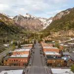 Telluride Colorado mountain town box canyon with Victorian buildings and snow-capped peaks, short-term rental market analysis 2026
