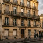 Parisian apartment building facade representing France Airbnb listing enforcement May 2026