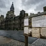 City hall building with permit notice board representing STR permit revocation enforcement 2026