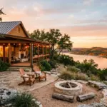 Stone and cedar Texas Hill Country short-term rental home on a limestone bluff overlooking Lake Travis at golden hour