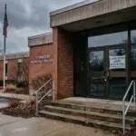 Municipal permit office with closed door representing STR permit freezes in 2026