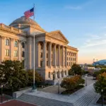 Federal courthouse exterior with American flag and stadium in background, representing STR legal status in World Cup host cities 2026