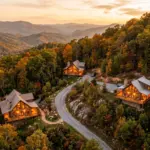 Aerial view of multiple short-term rental cabin properties in the Tennessee Smoky Mountains at golden hour