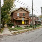 East Nashville residential street showing a craftsman house with city enforcement notice, illustrating Nashville STR enforcement gaps in 2026