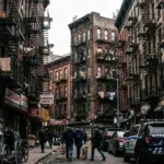 New York City apartment buildings and fire escapes representing Local Law 18 short-term rental enforcement impact